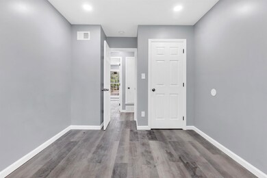 Interior space with baseboards, recessed lighting,