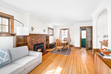 Living area featuring baseboards, crown molding, a