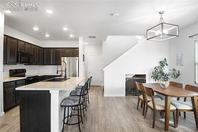 Kitchen with sink, hanging light fixtures, light h