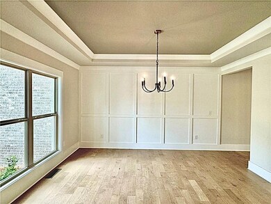 Unfurnished dining area with a tray ceiling, light