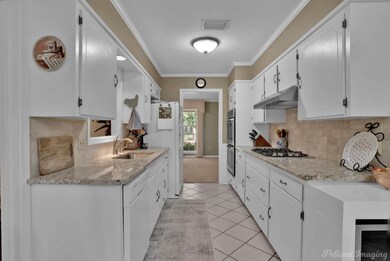 Kitchen with light colored carpet, decorative back