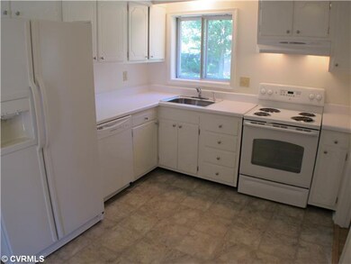 Kitchen - New vinyl flooring, all white cabinetry