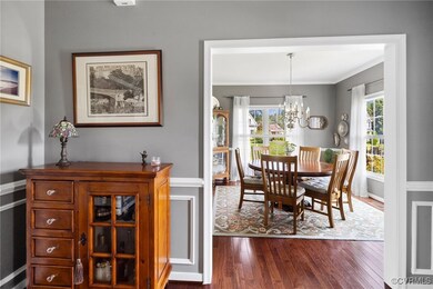 Dining space with ornamental molding, hardwood / w