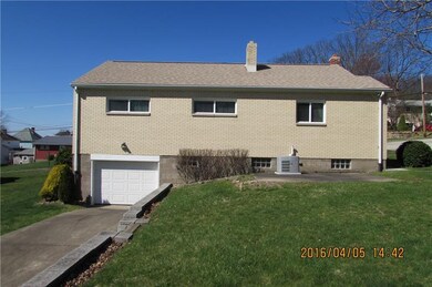 Rear of home with driveway access from alley.