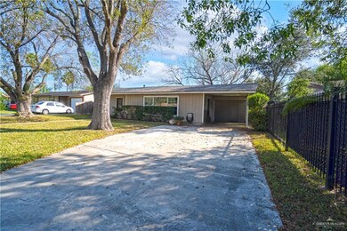 Ranch-style house featuring a front yard and a carport