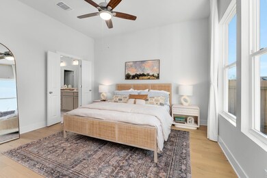 Bedroom featuring light wood-type flooring, baseb
