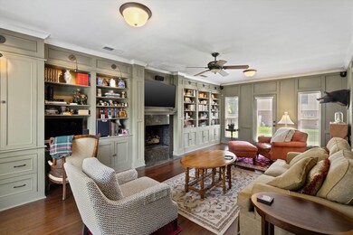 Living area with crown molding, a high end firepla
