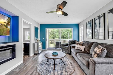 Living room with baseboards, visible vents, wood f