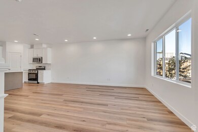 Unfurnished living room featuring light wood-style flooring and recessed lighting