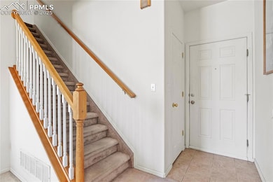 Stairway featuring visible vents and tile patterne