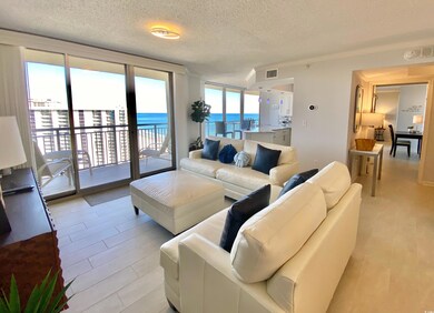 Living room with a textured ceiling, a water view,