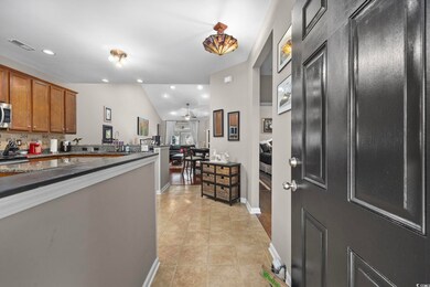 Kitchen with decorative backsplash, light tile pat