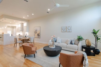 Living area featuring baseboards, light wood-type 