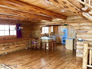 Breakfast bar and kitchen through archway to hall