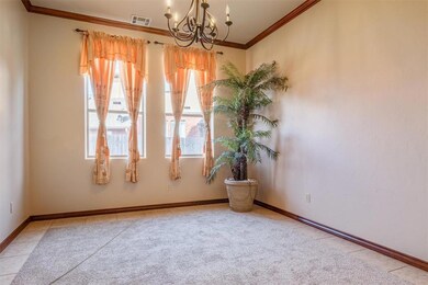 Spare room featuring crown molding, light tile flo