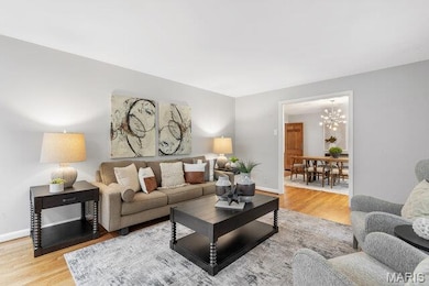 Living area featuring large picture window. lots of light and white oak flooring