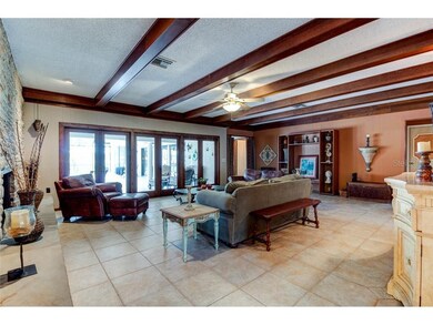 Living room off the entryway with doors to patio a