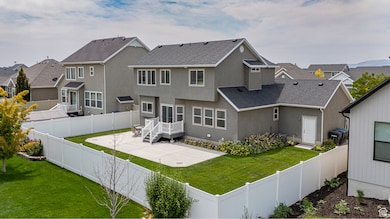 View of front of property with a shingled roof, a residential view, a fenced backyard, stucco siding, and a patio