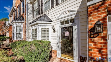 Entrance to property featuring brick siding
