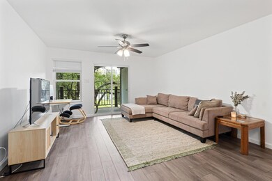 Living room featuring ceiling fan, dark wood-styl