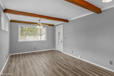 Spare room with beam ceiling, ornamental molding, 