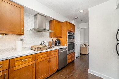 Kitchen with stainless steel appliances, baseboard