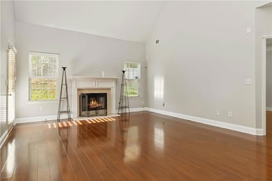Unfurnished living room with a warm lit fireplace,