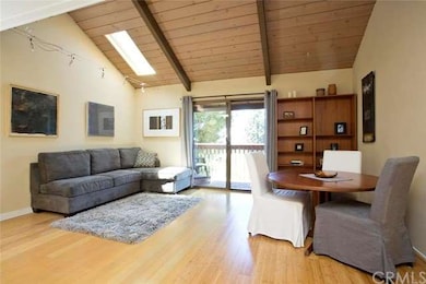 Living room with high wood beam ceiling, wood floo