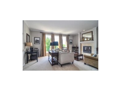 Great Room With Fireplace & Wall of Windows
