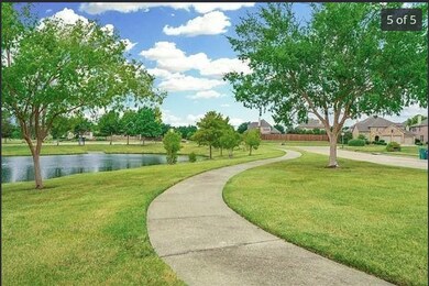Surrounding community featuring a lawn and a water view
