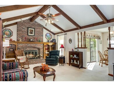 The vaulted Great Room has a gas log fireplace and