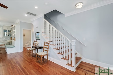 Warm inviting heart of pine flooring is featured t