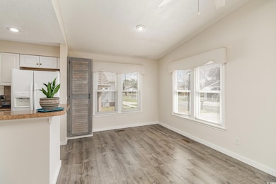 Unfurnished dining area with visible vents, basebo