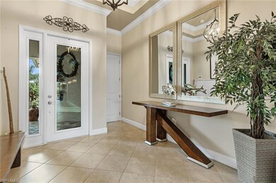 Grand foyer with tray ceiling, crown molding and diagonally laid tiles welcomes you in.