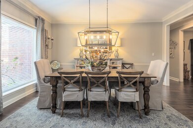 Dining area with ornamental molding, dark wood-typ