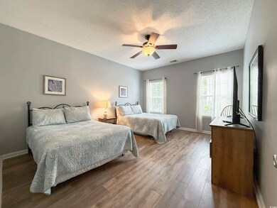 Bedroom with a textured ceiling, baseboards, ceili