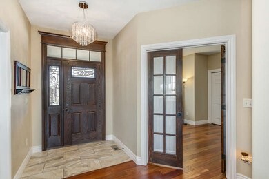 Tiled entry with crystal chandelier