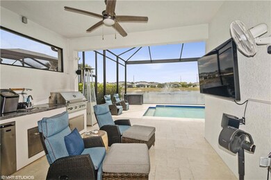 Outdoor pool with an outdoor kitchen, a ceiling fan, a grill, a patio area, and a lanai