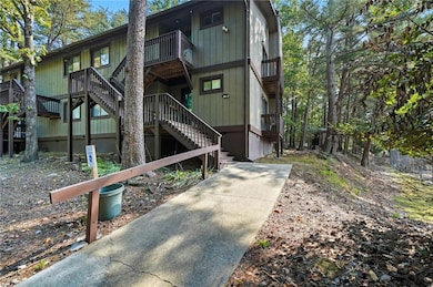 Back of house with stairway and a wooden deck