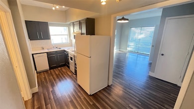 View of living/sleeping area and updated kitchen from the cozy dining nook.