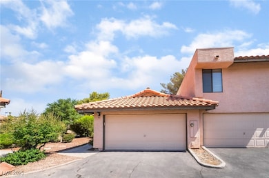 View of front of property with a tile roof, stucco