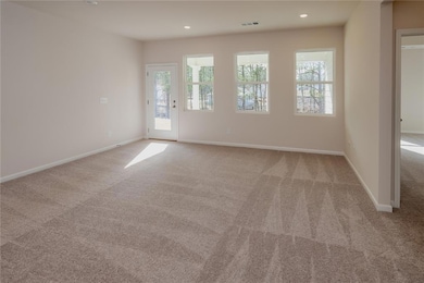 Carpeted spare room featuring baseboards and recessed lighting
