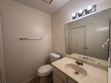 Half bath with vanity, tile patterned floors, and