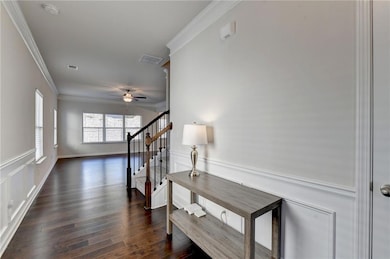 Hallway featuring dark wood-type flooring, stairs,
