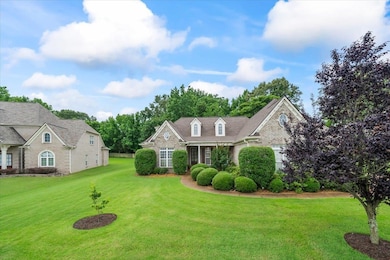 View of front of house featuring a front yard and brick siding