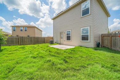 Back of house with a lawn, a patio area, a fenced