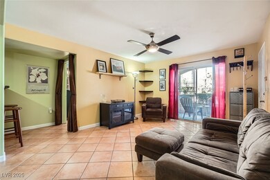 Tiled living room featuring ceiling fan