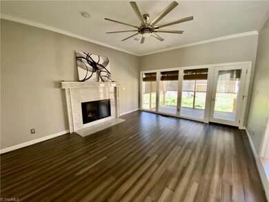 Den with gas logs in the fireplace. Leads to screened-in porch.