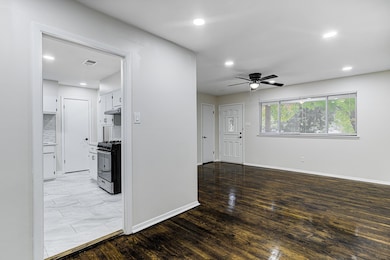 Interior space with ceiling fan and light wood-typ