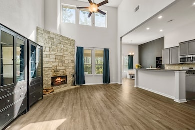 The living room welcomes you with soaring two-stor